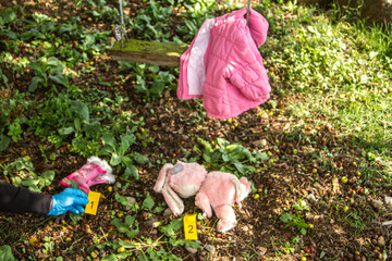 forensic investigations into the kidnapping of children on a swing in the garden with evidence in evidence marked with yellow cards from the art of investigators with evidence 
