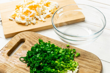 chopped eggs and green onions. Preparing salad, baking fillings.