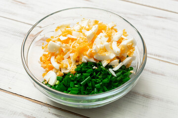 chopped eggs and green onions. Preparing salad, baking fillings.