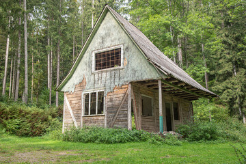 Abandoned old wooden house in the forest.
