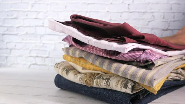 Close up of stack of cloths on table.