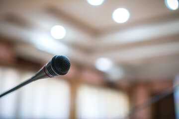 Microphone for speech on abstract blurred conference hall Prepare for speaker on stage in seminar...