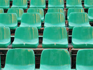 Fototapeta premium Amphitheater dark green seats abstract background. Places in the stands of the stadium
