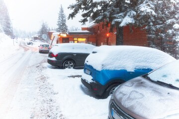 Heavy snowfall in the mountains with parking cars