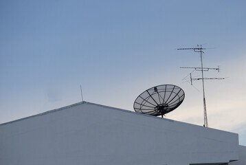 Satellite dish receivers above building roofs, communication technology in the digital world
