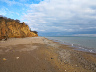 Rockslide. Mountain landslide in an environmentally hazardous area. Large cracks in earth, descent of large layers of earth blocking road. Mortal danger of dam at foot of landslide slopes of mountain