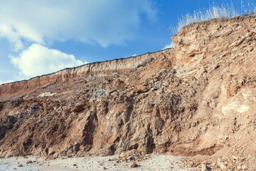 Rockslide. Mountain landslide in an environmentally hazardous area. Large cracks in earth, descent of large layers of earth blocking road. Mortal danger of dam at foot of landslide slopes of mountain