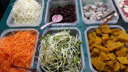 Multi colored fruits and vegetables Arranged in a tray Sell in supermarket.