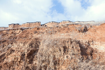 Rockslide. Mountain landslide in an environmentally hazardous area. Large cracks in earth, descent...