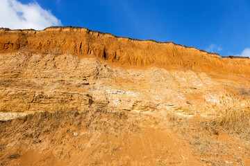 Rockslide. Mountain landslide in an environmentally hazardous area. Large cracks in earth, descent of large layers of earth blocking road. Mortal danger of dam at foot of landslide slopes of mountain