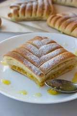 Sweet pastries in the shape of a square with an interesting pattern, stuffed with oranges and lemons,