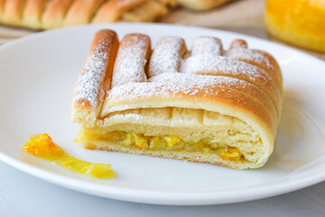 Sweet pastries in the shape of a square with an interesting pattern, stuffed with oranges and lemons,