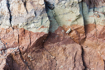 View bird's-eye view. Background of mountain landslide in an environmentally hazardous area. Large cracks in the ground, the descent of soil layers, coquina. Deadly risk of coastal collapse