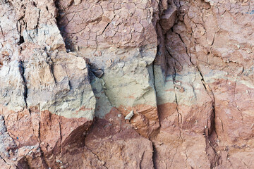 View bird's-eye view. Background of mountain landslide in an environmentally hazardous area. Large cracks in the ground, the descent of soil layers, coquina. Deadly risk of coastal collapse