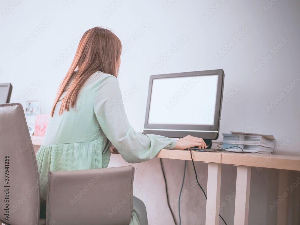 Poster back view of women use computer desktop blank screen.