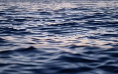Waves on the sea surface as a background. Seascape during sunset. Nature composition. Mediterranean sea.