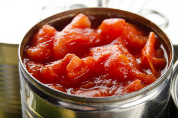 Canned sliced tomatoes in just opened tin can. Non-perishable food