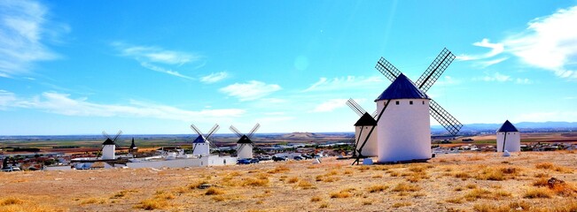 Artistic photo of windmills with Campo de Criptana town in the background.