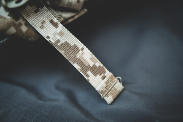 camo webbing close up shot over a grey background