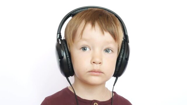 A portrait of a lovely boy with big headphones close up