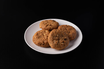 Cookies in a white plate on a black background