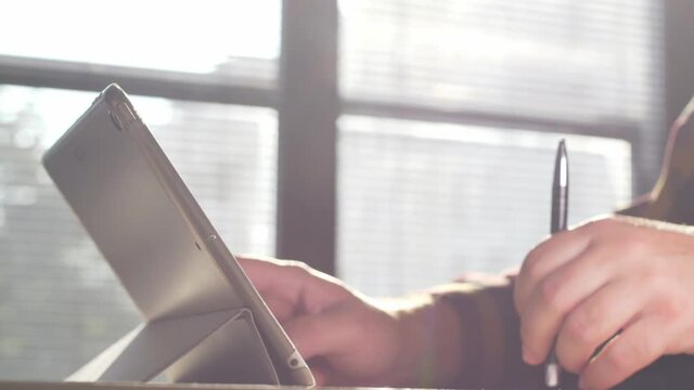 Man using tablet. Close up footage of person working on tablet.