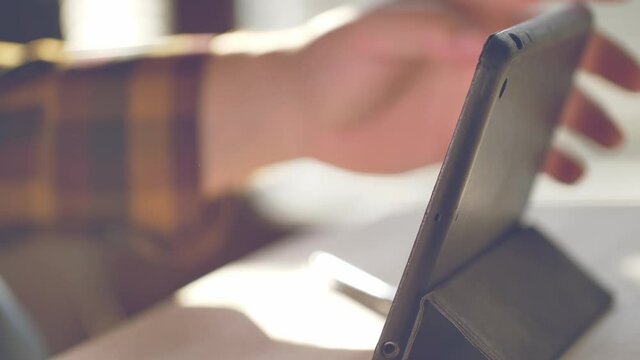 Man using tablet. Close up footage of person working on tablet.