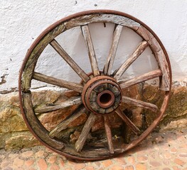 Old wagon wheel made of wood and iron.