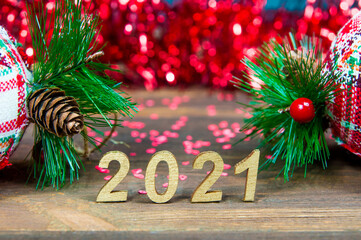 2021 and Christmas toys on a wooden background close-up