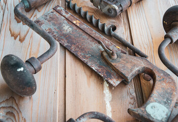 ,vintage  hand tools. on wooden table ,saw and hand drill  & bit labour day.