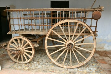 Fototapeta na wymiar Antique four-wheeled cavalry wagon or trailer, built in wood and iron.