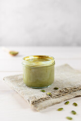 Pumpkin paste in a glass jar on a napkin.