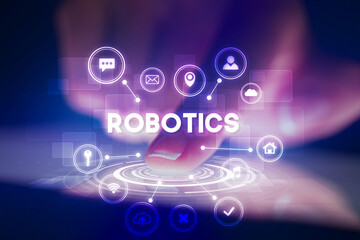 Finger touching tablet with web technology icons and ROBOTICS inscription, web technology concept