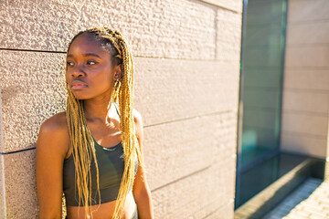 latin hispanic girl with long yellow dreadlocks pigtails working out outdoor in ste streets in sity...