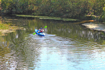 a canoe trip with a child on the autumn river