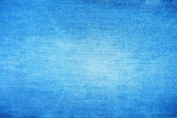 Top view of bright blue jeans fabric with white stains for background and decoration Textile texture and rough surface of jeans