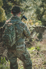 Fototapeta premium Soldier in a combat situation. Men play airsoft.