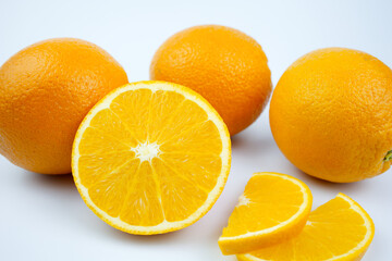 half cut and slice orange fruit on the white background