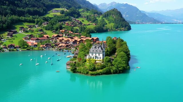 Beautiful Schloss Seeburg castle in the middle of a blue lake. Perfect travel destination for vacations under the blue sky in Swiss - 4K