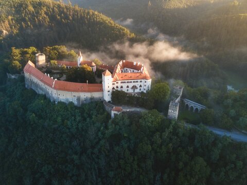 Bitov Medieval castle in South Moravia region during amazing sunrise, Czech republic, Europe. Aerial drone view. Summer or autumn time.
Misty and sunny atmosphere.