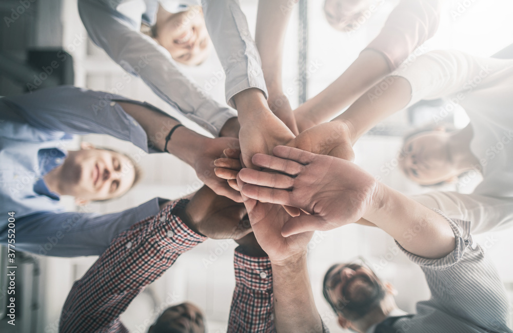 Fototapete stack of hands. unity and teamwork concept.