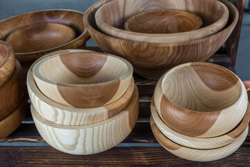 Handmade wooden tableware is sold at the street market. Souvenir production.