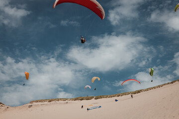 paraglides above the duna de Pila in France, near the Atlantic ocean