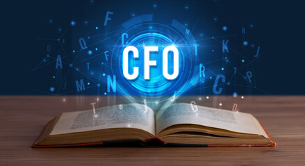 CFO inscription coming out from an open book, digital technology concept