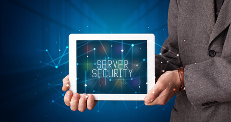 Young business person working on tablet and shows the digital sign: SERVER SECURITY
