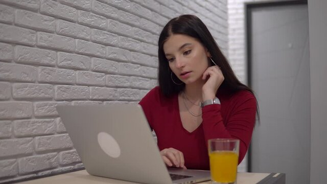 Focused woman working with laptop, freelance distance remote work self isolation