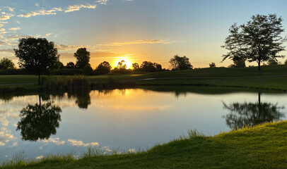 Fototapeta na wymiar sunrise golf course pond reflections