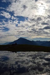 Reflections of the mountains around Lake Como in Lombardy, Northern Italy