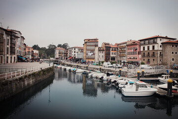 Fototapeta na wymiar Old picturesque town in Asturias with a small port full of boats