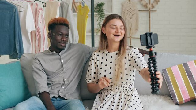 A Girl and Boy Takes Pictures of Themselves, Conducts a Blogging. A Bloggers Creating a New Content for Video Blog. Cute Lady and Young Man Shares the News With Her Followers during Vlogging.